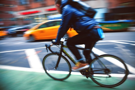 Bike rider riding through streets of New York