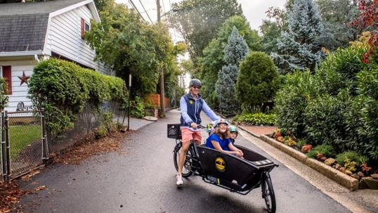 Attorney Dan Flanzig on Bicycle with Children in attached side car seat